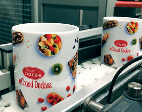 Full color corporate mug using dye sublimation printing process in production facility