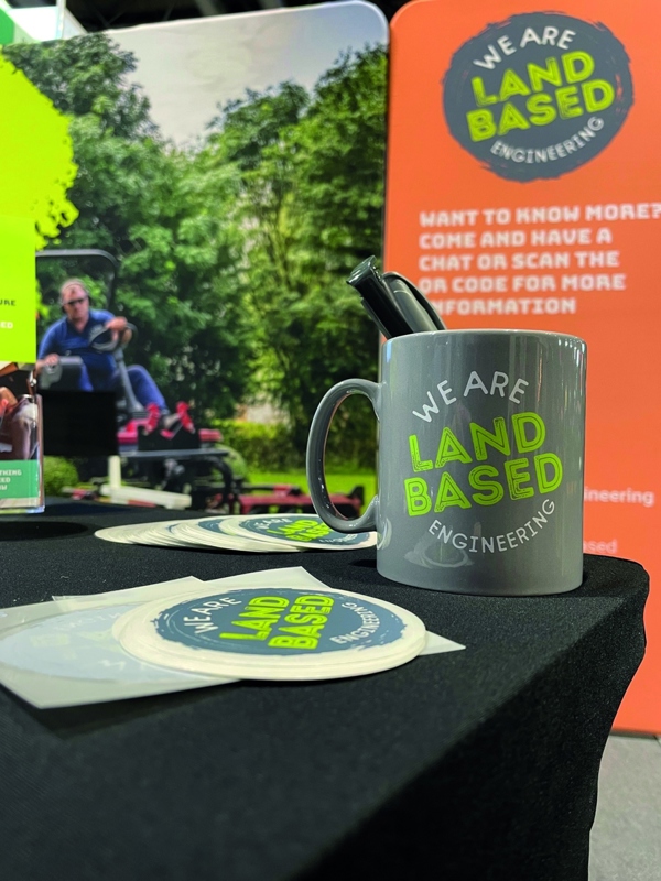 Branded promotional merchandise set including logo printed mugs, pens, stickers and custom banners for events