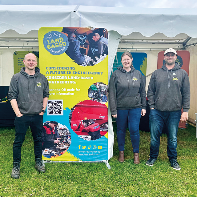 Engineering team showcasing custom printed corporate event banner